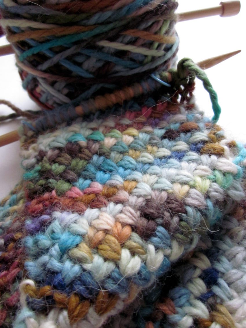 A multi-colored cross stitch scarf in progress. 